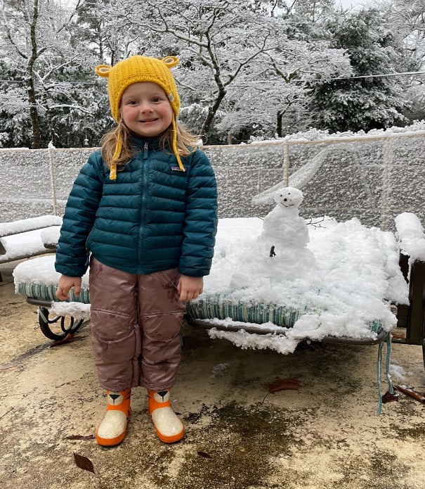 Little girl with snowman