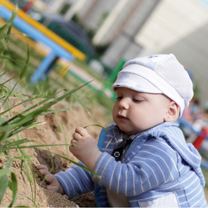 Young child touching grass